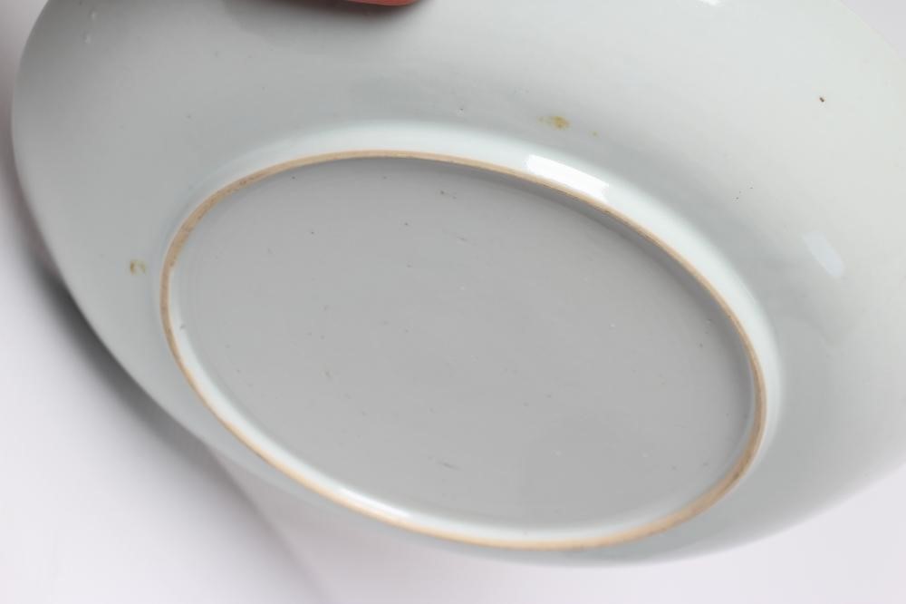 TWO CHINESE PORCELAIN SAUCER DISHES painted in underglaze blue with a flower spray within a diapered Image