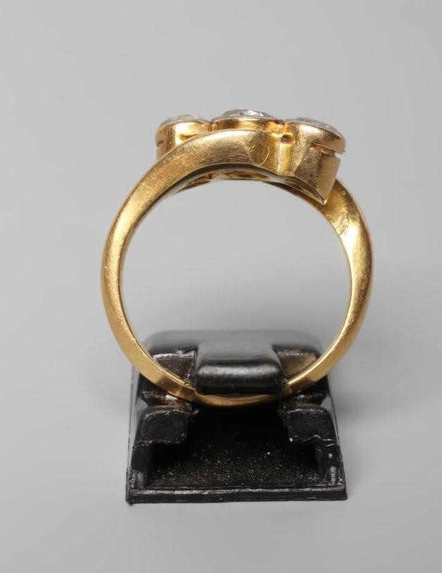 A THREE STONE DIAMOND CROSSOVER RING, the mix cut stones totalling approximately 1ct, collet set to Image