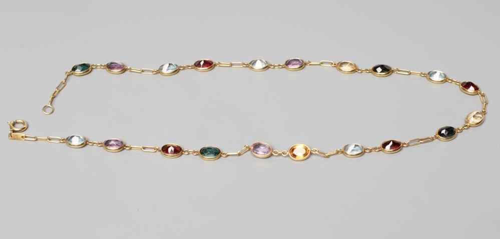 A MULTI-GEM SET NECKLACE, the collet set stones including aquamarine, garnet and amethyst each with Image