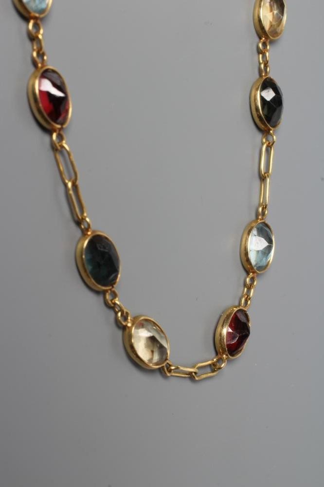 A MULTI-GEM SET NECKLACE, the collet set stones including aquamarine, garnet and amethyst each with Image