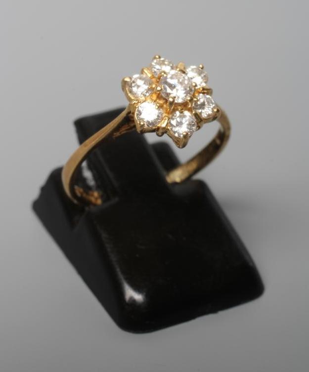 A SEVEN STONE DIAMOND CLUSTER RING, the brilliant cut stones totalling approximately 0.65cts, claw Image