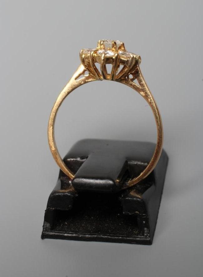 A SEVEN STONE DIAMOND CLUSTER RING, the brilliant cut stones totalling approximately 0.65cts, claw Image