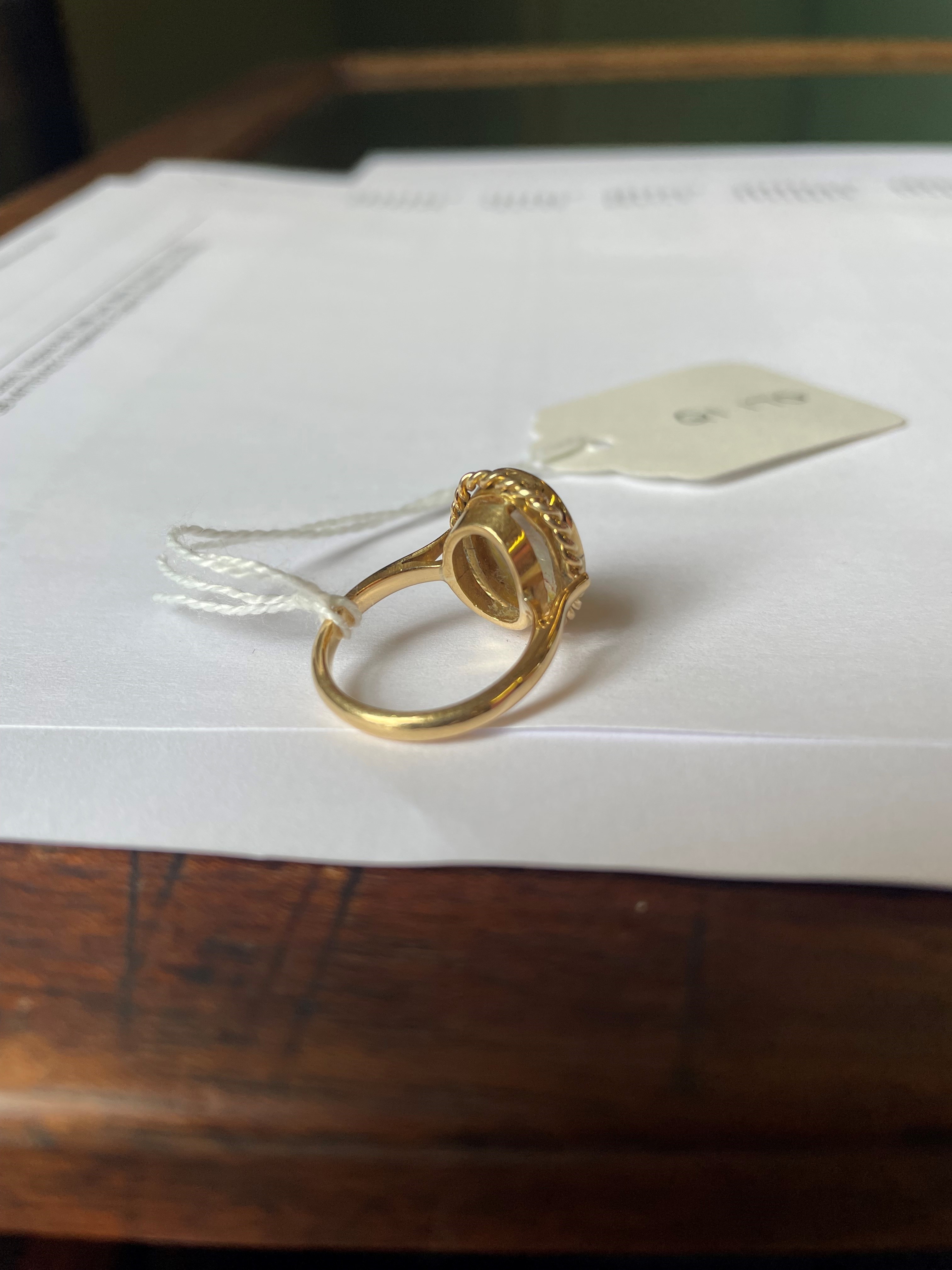 AN OPAL DRESS RING, the oval cabochon polished stone collet set to a rope twist mount and plain Image