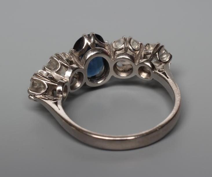 A SAPPHIRE AND DIAMOND FIVE STONE HALF HOOP RING Image