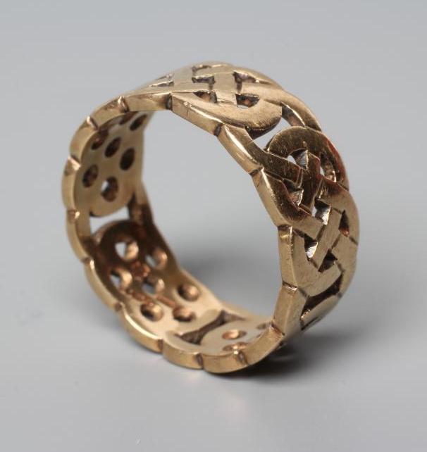 A 9CT GOLD RING of pierced Celtic knot design, London 2000, size Q, 6.1g, cased and boxed (Est. plus Image