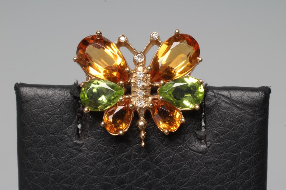 A CITRINE, PERIDOT AND DIAMOND BUTTERFLY BROOCH, the facet cut stones claw set to a 9ct gold frame, Image