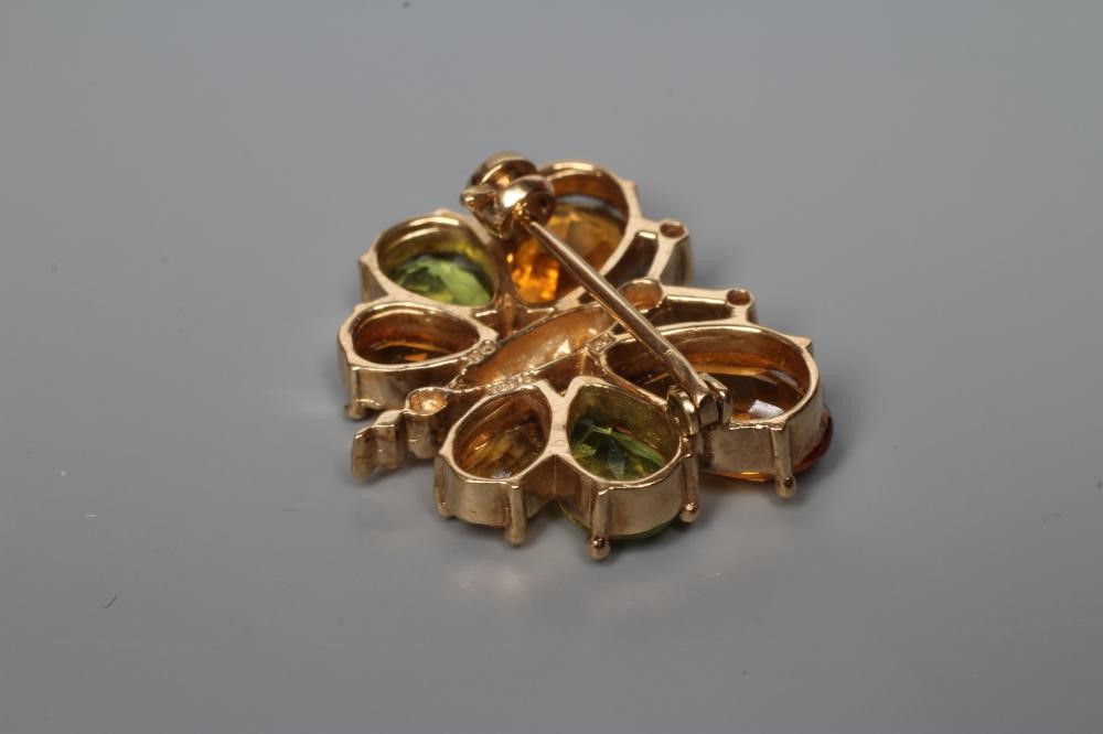 A CITRINE, PERIDOT AND DIAMOND BUTTERFLY BROOCH, the facet cut stones claw set to a 9ct gold frame, Image