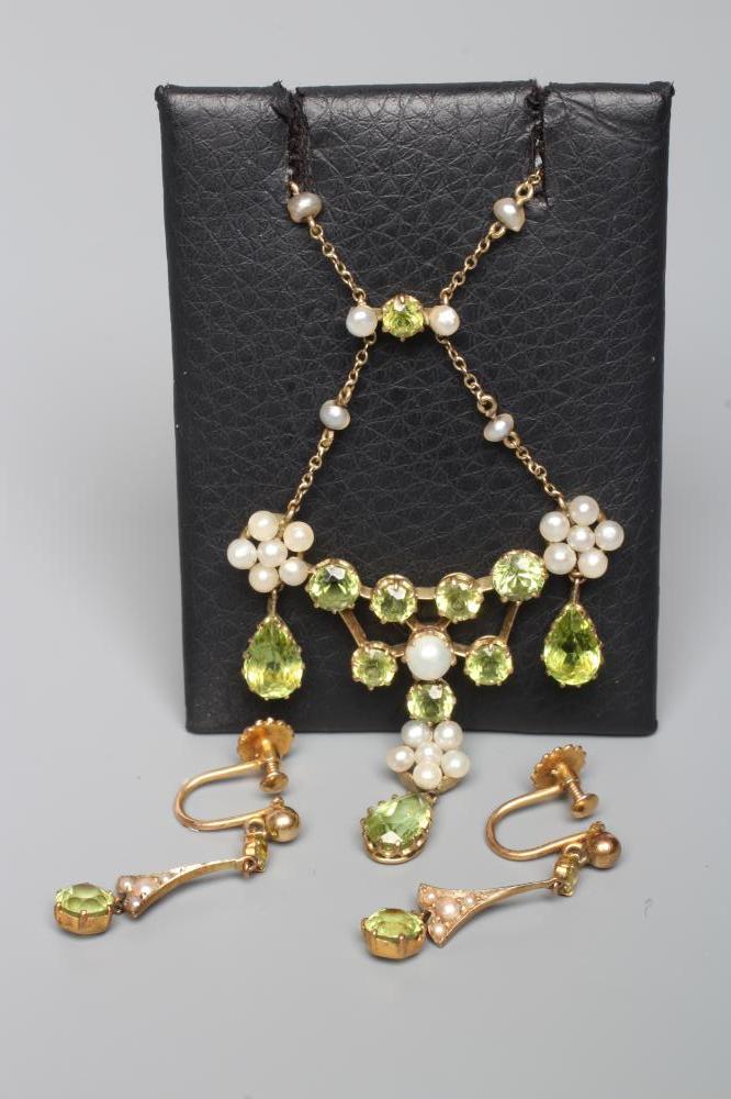 AN EDWARDIAN PERIDOT AND SEED PEARL CHANDELIER PENDANT of typical wirework form claw set with seven Image