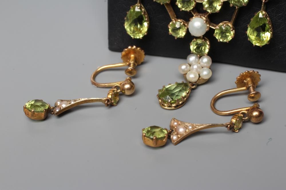 AN EDWARDIAN PERIDOT AND SEED PEARL CHANDELIER PENDANT of typical wirework form claw set with seven Image