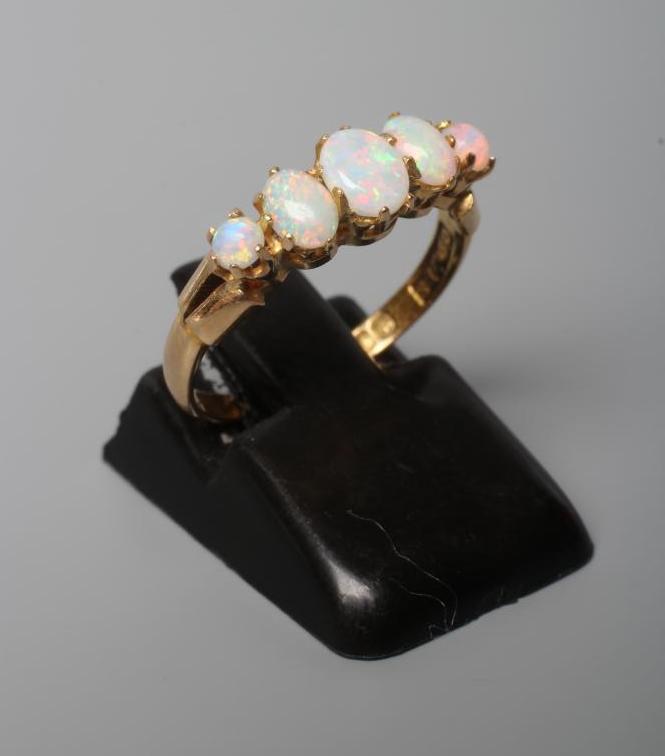 AN EDWARDIAN FIVE STONE OPAL RING Image