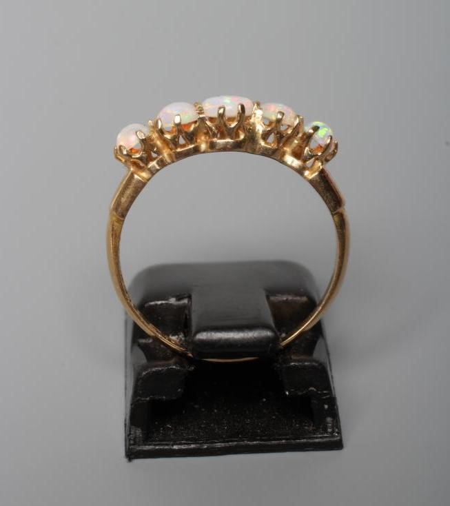 AN EDWARDIAN FIVE STONE OPAL RING Image