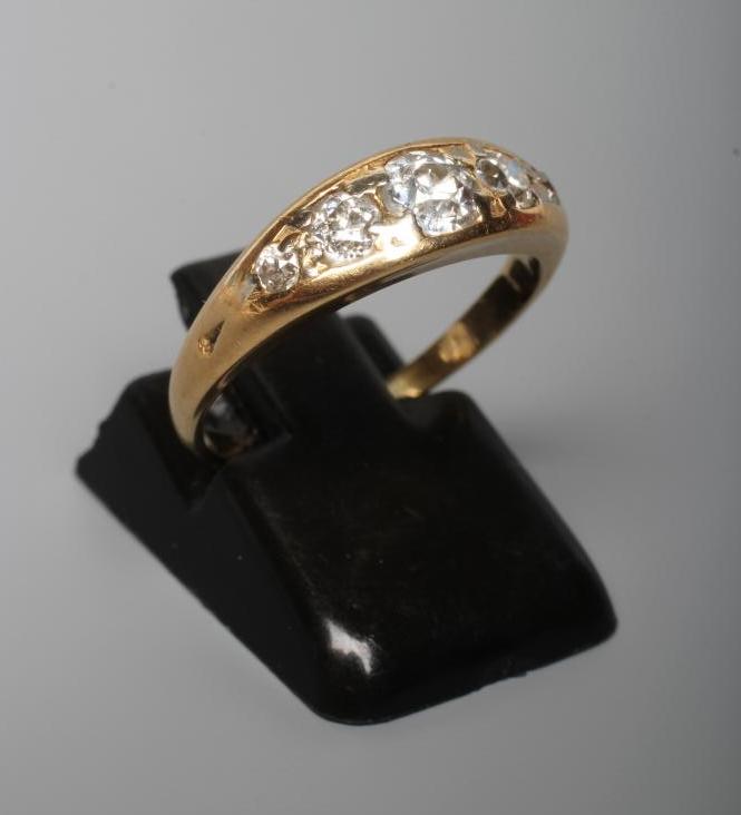 A FIVE STONE DIAMOND RING, the point set graduated stones totalling approximately 0.78cts, in a boat Image