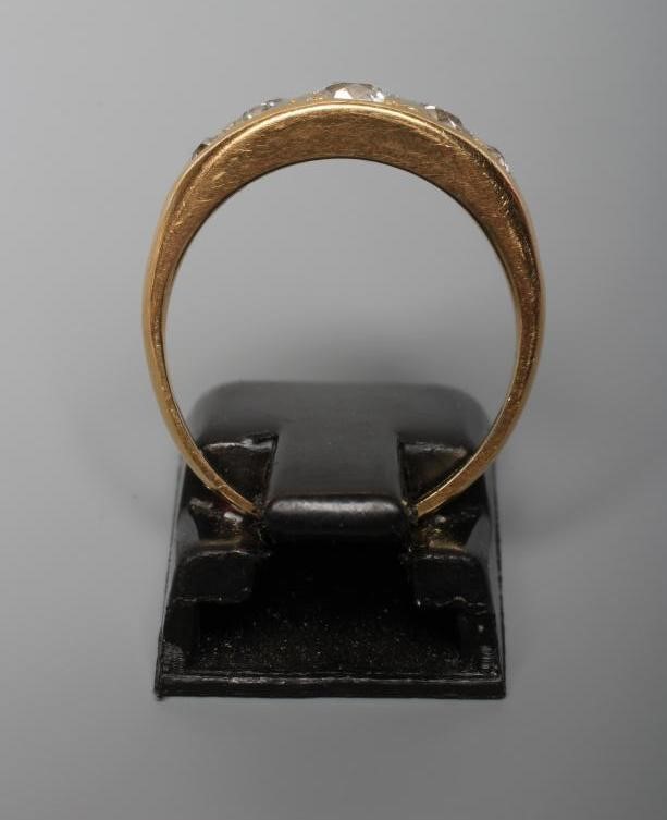 A FIVE STONE DIAMOND RING, the point set graduated stones totalling approximately 0.78cts, in a boat Image