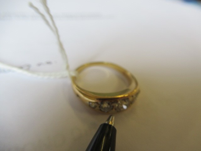 A FIVE STONE DIAMOND RING, the point set graduated stones totalling approximately 0.78cts, in a boat Image