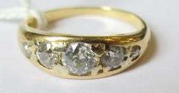 A FIVE STONE DIAMOND RING, the point set graduated stones totalling approximately 0.78cts, in a boat Image