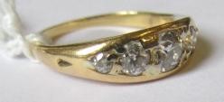 A FIVE STONE DIAMOND RING, the point set graduated stones totalling approximately 0.78cts, in a boat Image