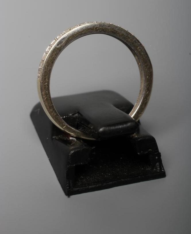 A DIAMOND HALF HOOP ETERNITY RING, the nineteen small brilliant cut stones pave set to a plain 9ct Image