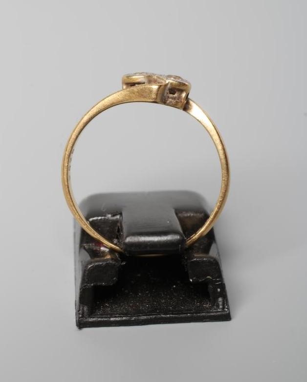 AN ART DECO TWO STONE DIAMOND CROSSOVER RING, the illusion set stones set to angular shoulders and a Image