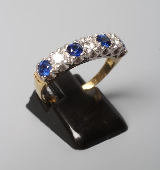 A SAPPHIRE AND DIAMOND HALF HOOP RING, the four sapphires and three brilliant cut diamonds point set Image