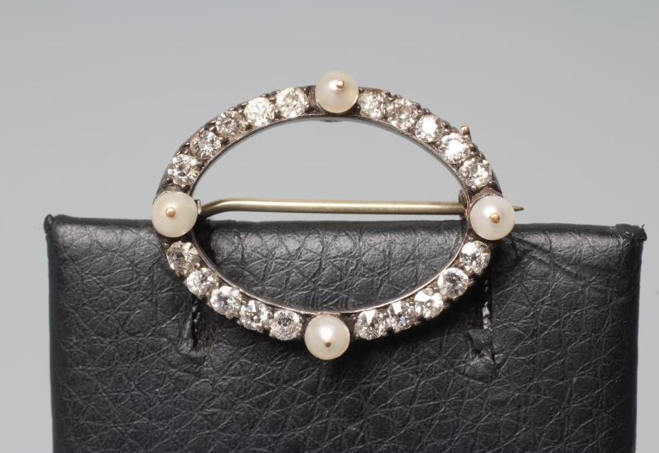 A LATE VICTORIAN DIAMOND AND PEARL OVAL BROOCH, the four peg set pearls with twenty small diamonds Image