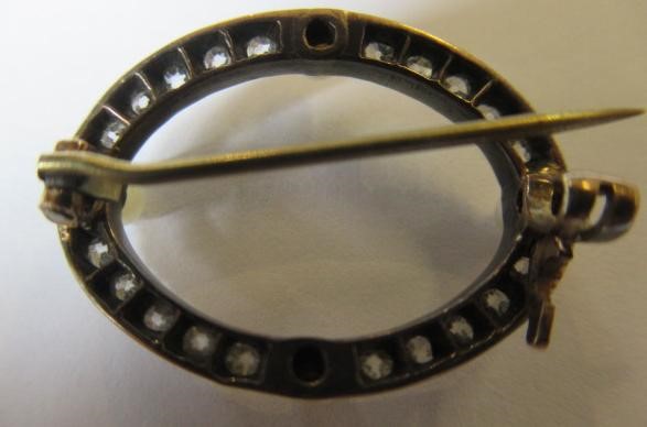 A LATE VICTORIAN DIAMOND AND PEARL OVAL BROOCH, the four peg set pearls with twenty small diamonds Image