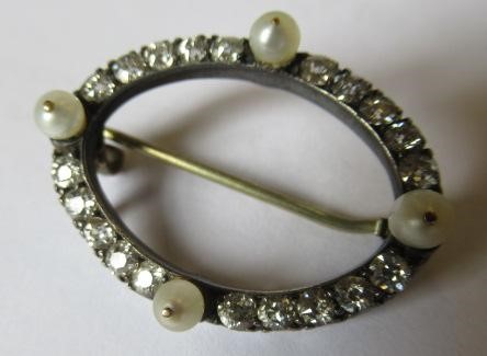 A LATE VICTORIAN DIAMOND AND PEARL OVAL BROOCH, the four peg set pearls with twenty small diamonds Image