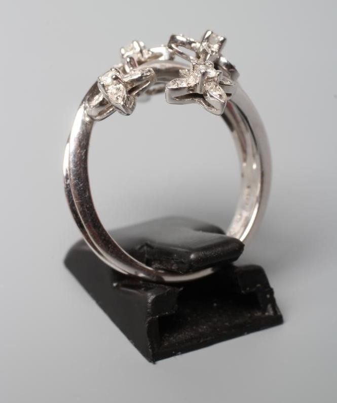 A MODERN TREMBLEUSE DIAMOND COCKTAIL RING, the five clusters set to knife edge shoulder bars and a Image