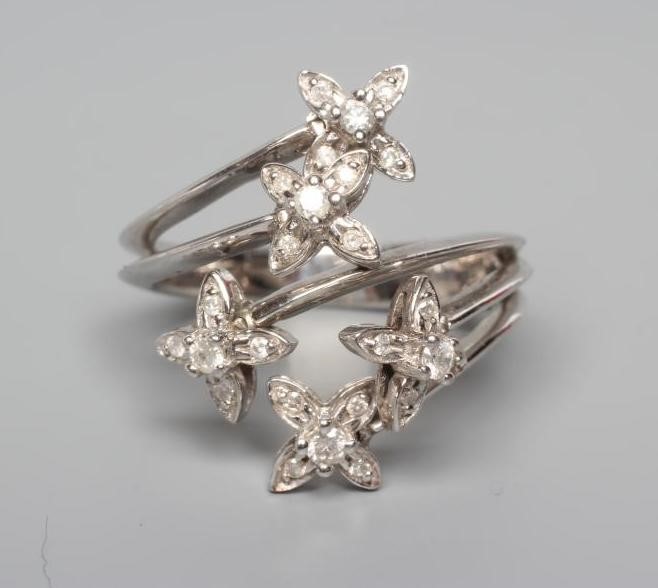 A MODERN TREMBLEUSE DIAMOND COCKTAIL RING, the five clusters set to knife edge shoulder bars and a Image