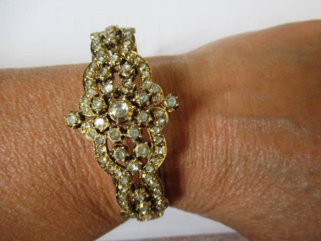 A DIAMOND STIFF HINGED BANGLE Image