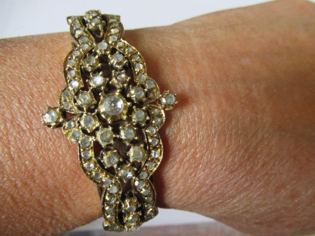 A DIAMOND STIFF HINGED BANGLE Image