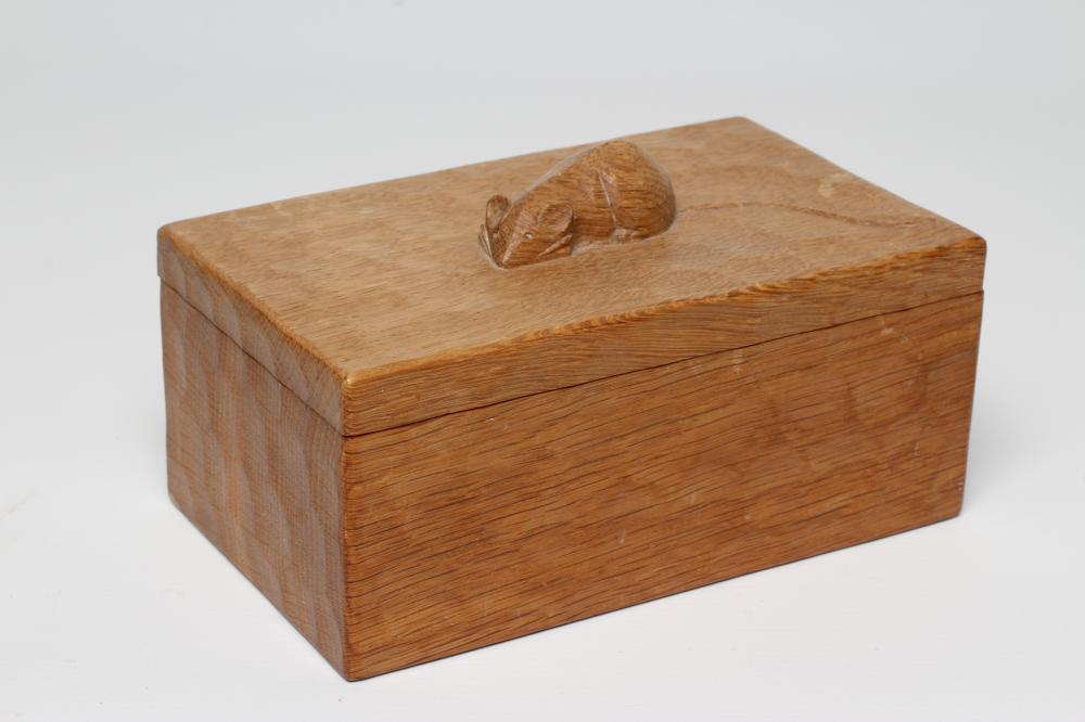 A ROBERT THOMPSON ADZED OAK TRINKET BOX of oblong form, the lift-off cover centred by carved mouse Image