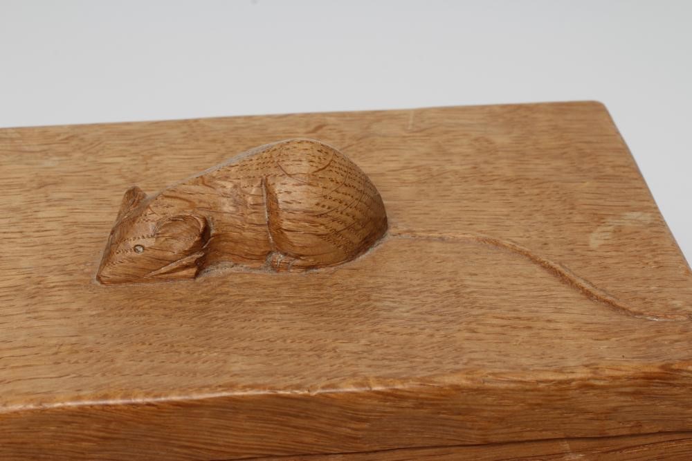 A ROBERT THOMPSON ADZED OAK TRINKET BOX of oblong form, the lift-off cover centred by carved mouse Image