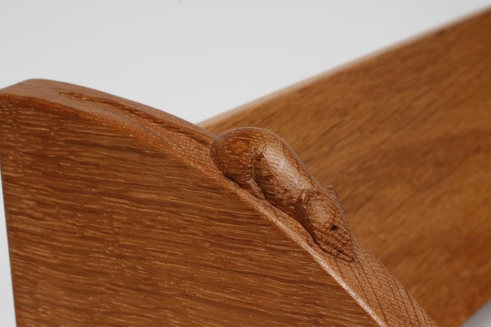 A ROBERT THOMPSON ADZED OAK BOOK TROUGH of usual form with quadrant ends and carved mouse trademark Image