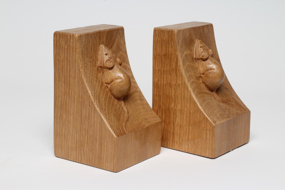 A PAIR OF ROBERT THOMPSON ADZED OAK BOOKENDS of dished square form with carved mouse trademark in Image