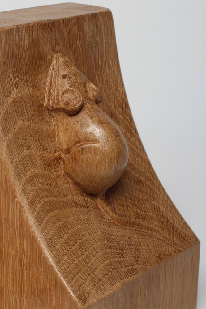 A PAIR OF ROBERT THOMPSON ADZED OAK BOOKENDS of dished square form with carved mouse trademark in Image