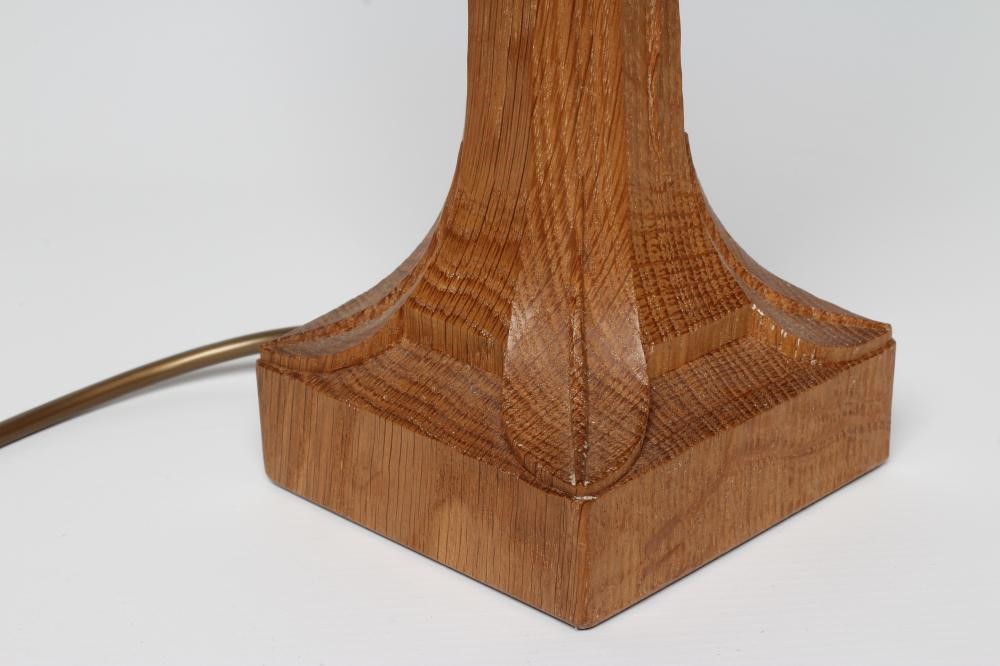A ROBERT THOMPSON ADZED OAK TABLE LAMP of candlestick form Image