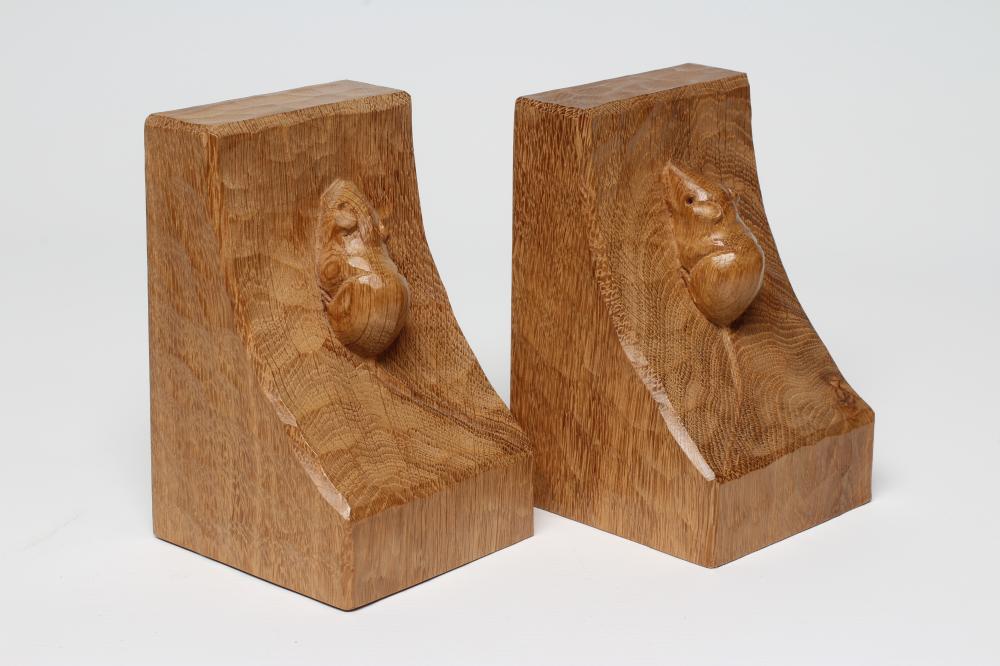 A PAIR OF ROBERT THOMPSON ADZED OAK BOOKENDS of dished square form with carved mouse trademark in Image