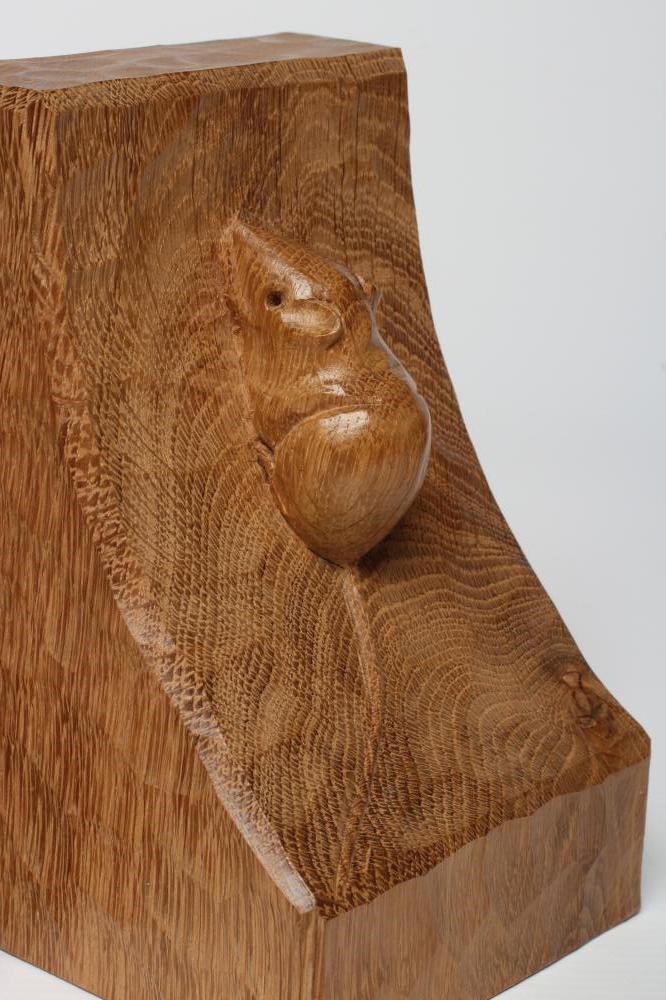 A PAIR OF ROBERT THOMPSON ADZED OAK BOOKENDS of dished square form with carved mouse trademark in Image