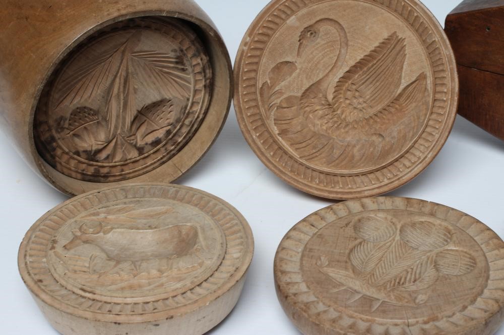 A COLLECTION OF TREEN BUTTER MOULDS AND PRESSES Image