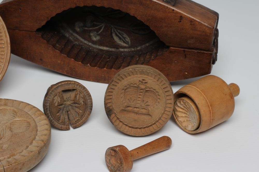 A COLLECTION OF TREEN BUTTER MOULDS AND PRESSES Image