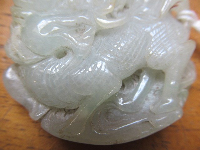 A CHINESE TWO TONE JADE PANEL carved and pierced with a man holding a cup Image