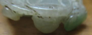 A CHINESE TWO TONE JADE PANEL carved and pierced with a man holding a cup Image