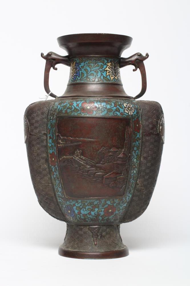 A CHINESE CLOISONNE ENAMEL VASE of two handled ovoid form, cast with panels of figures in landscapes Image