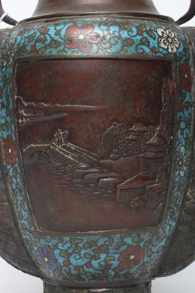 A CHINESE CLOISONNE ENAMEL VASE of two handled ovoid form, cast with panels of figures in landscapes Image