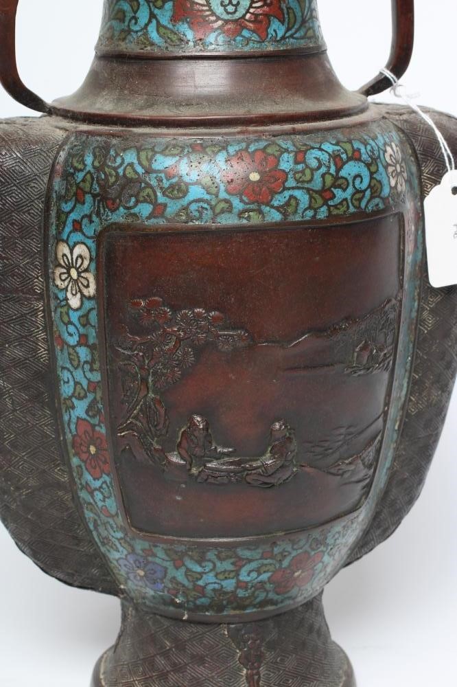 A CHINESE CLOISONNE ENAMEL VASE of two handled ovoid form, cast with panels of figures in landscapes Image