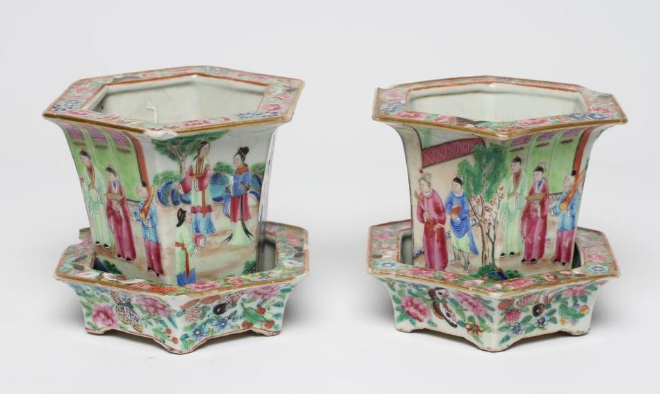 A PAIR OF CANTONESE PORCELAIN FAMILLE ROSE HEXAGONAL CACHE-POTS AND STANDS painted with a continous Image