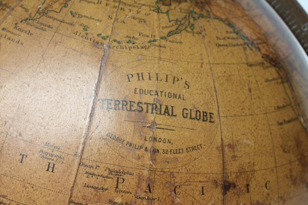 A PHILIPS 10" TERRESTRIAL TABLE GLOBE, early 20th century, raised on turned fruitwood stand (Est. Image