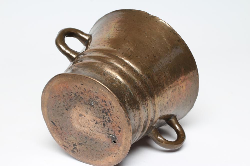 A BRONZE MORTAR, c.1700, the waisted ribbed body with two loop handles, 6 1/2" wide, together with a Image
