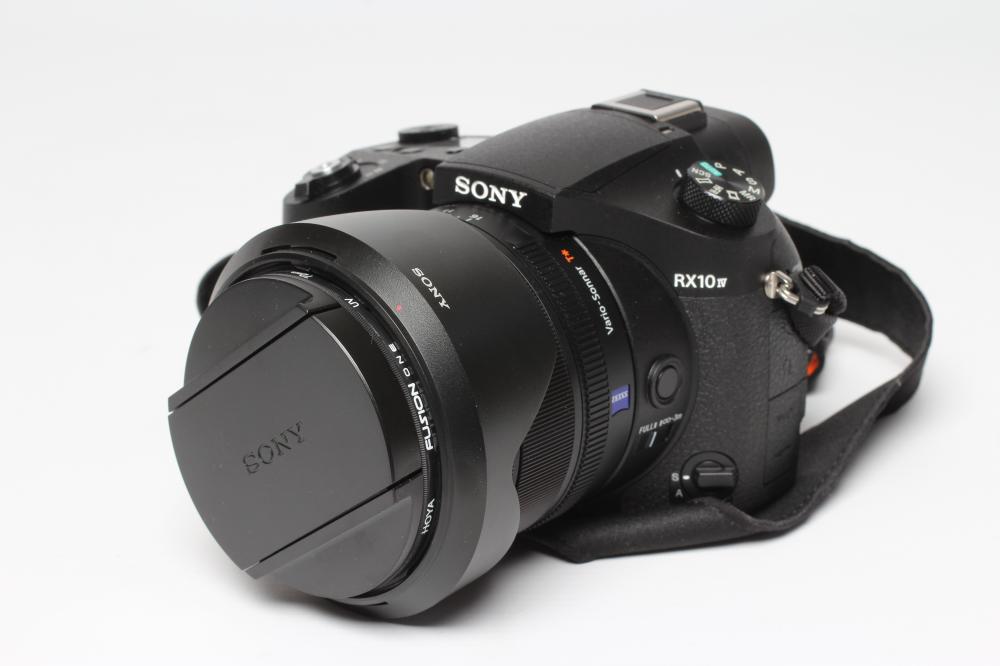 A SONY RX10 IV DIGITAL CAMERA, together with a Zeiss Vario-Sonnar 2.4-4/8.8-220 lens, boxed (Est. Image