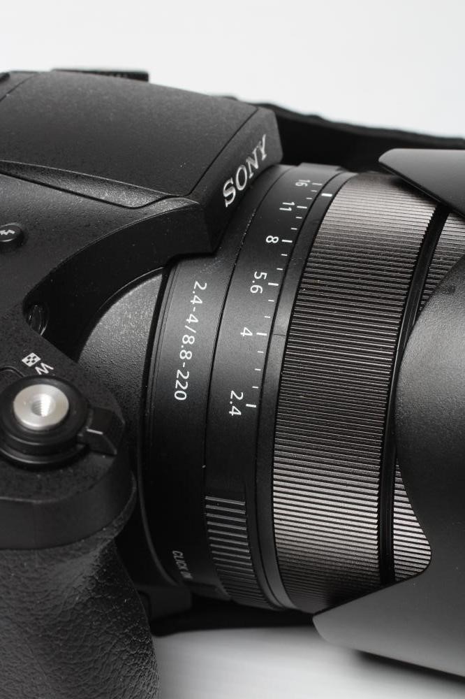 A SONY RX10 IV DIGITAL CAMERA, together with a Zeiss Vario-Sonnar 2.4-4/8.8-220 lens, boxed (Est. Image